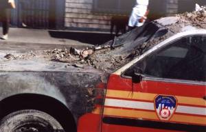 FDNY car is toasted and mildly deformed, while the door appears undamaged and the window glass is intact
