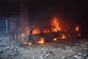 minivan is consumed by flames. The fire rages inside the vehicle
